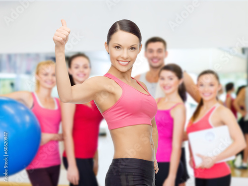 personal trainer with group in gym