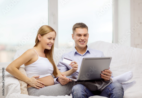 expecting family with laptop and credit card