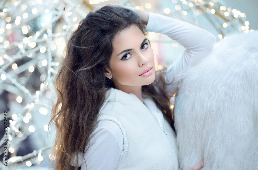 Winter Beauty Woman. Beautiful brunette girl with long hair posi