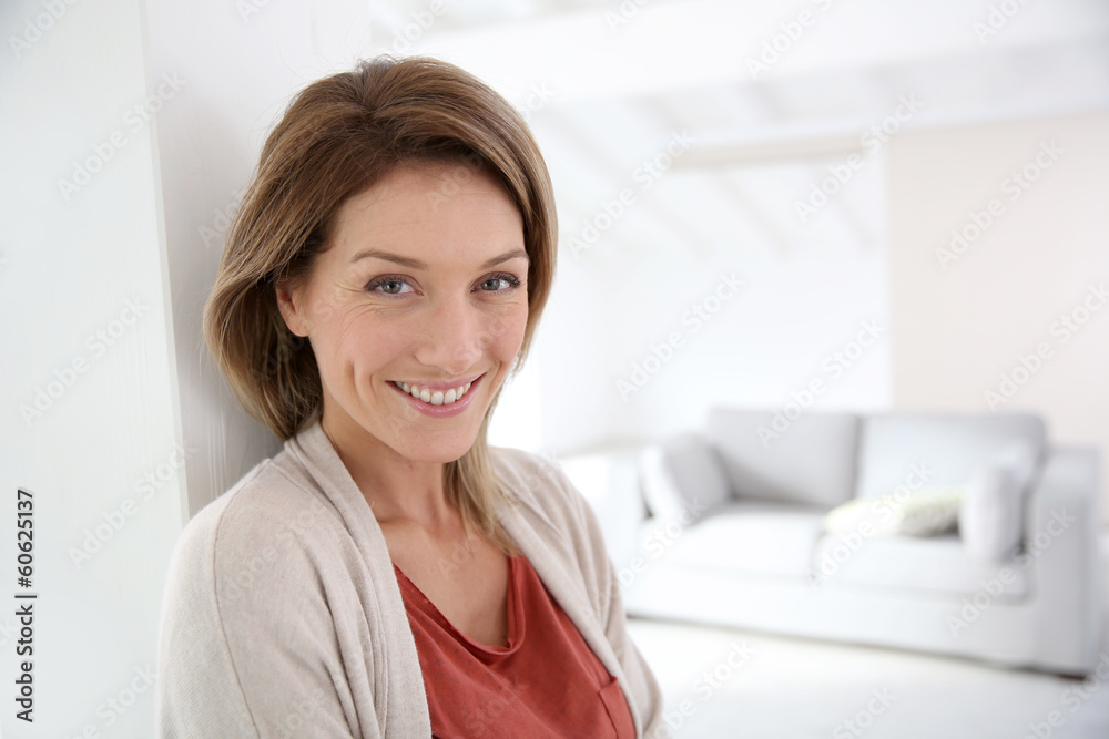 Middle-aged woman standing in modern home Middle-aged woman standing in modern home