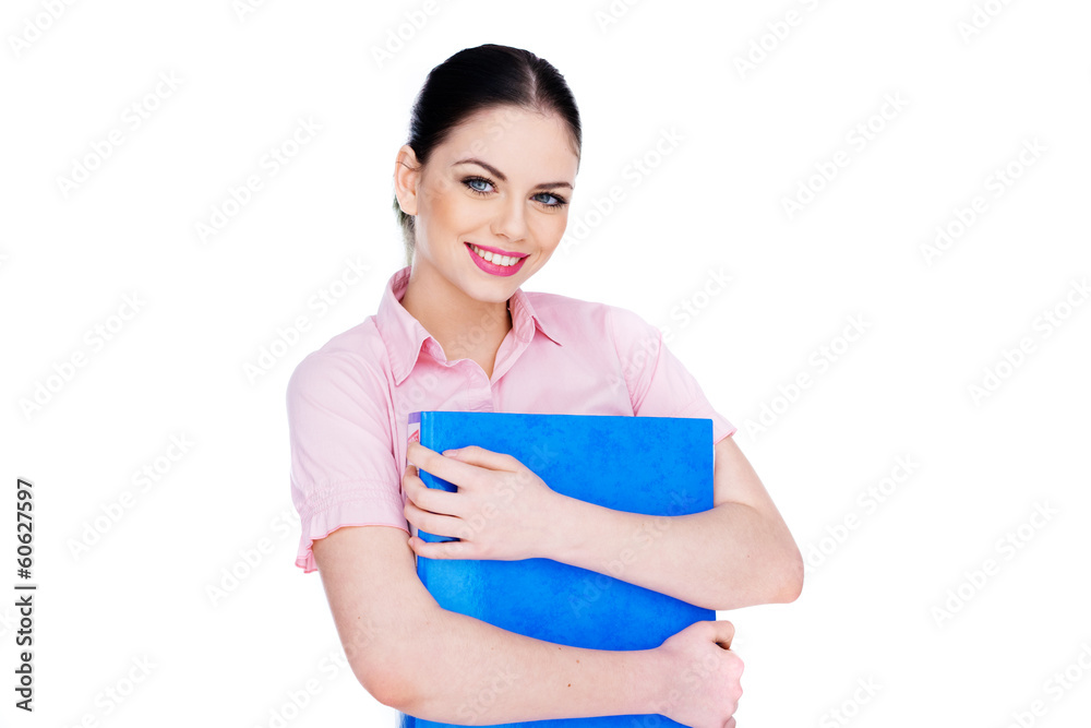 Young woman smiling while holding a blue folder Young woman smiling while holding a blue folder