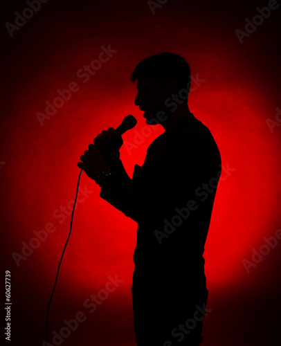 Musician silhouette on dark color background