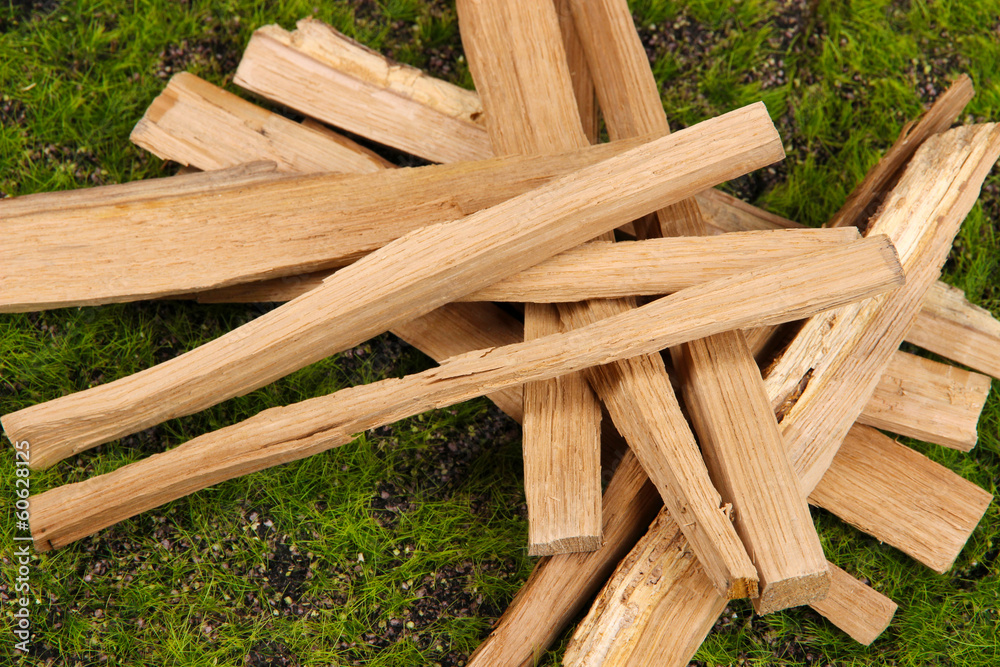 Stack of firewood on grass close up