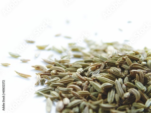 pile of caraway  seeds isolated on white background photo