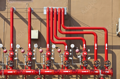 splinker alarm system red water pipe brown wall outdoor
