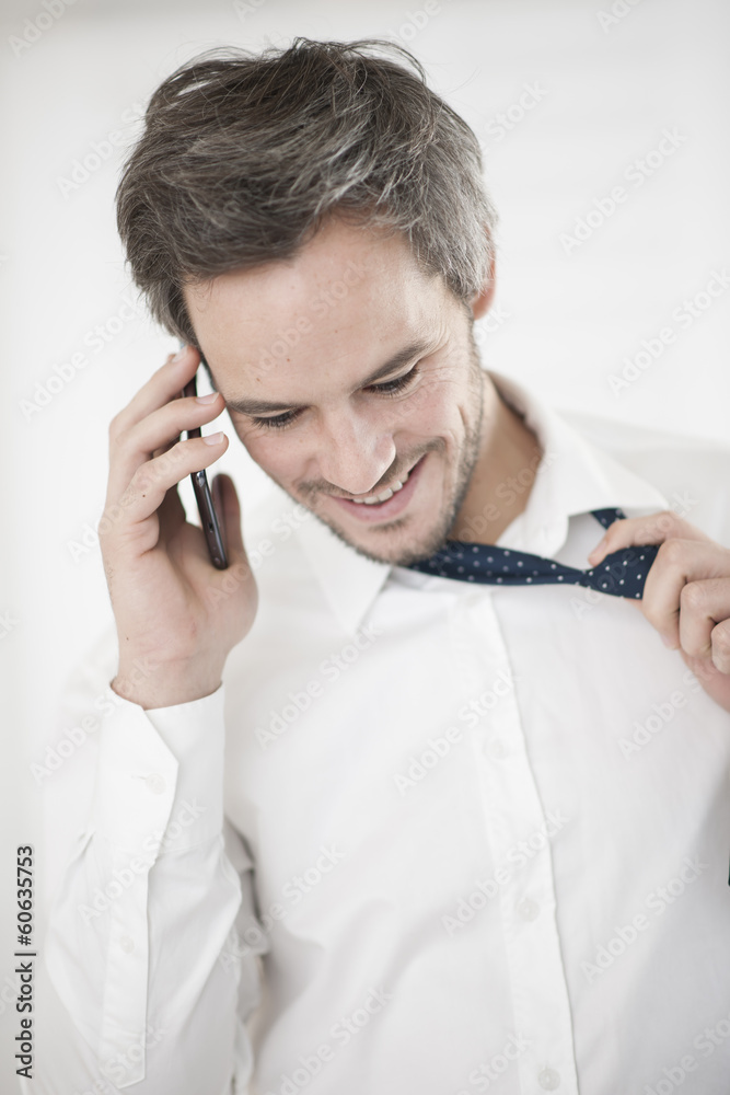businessman at phone take off his tie