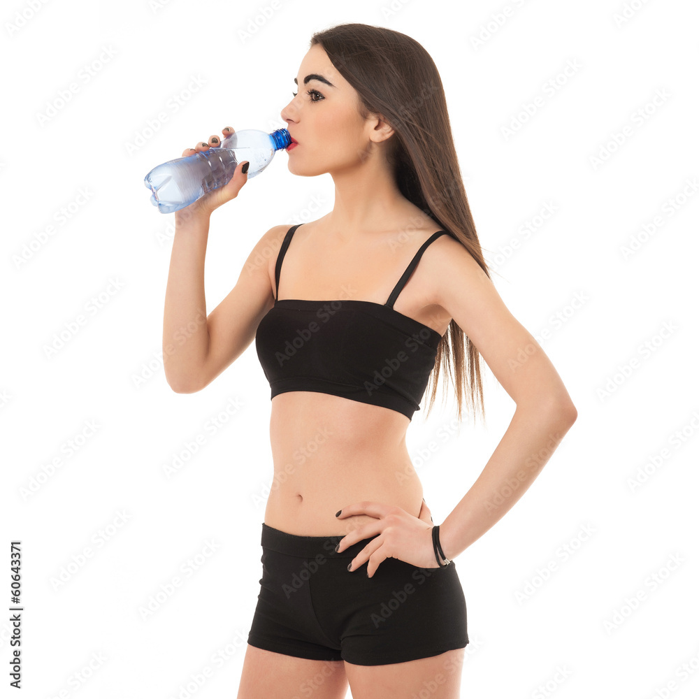 Sporty young woman drinking water, isolated against white backgr Sporty young woman drinking water, isolated against white backgr