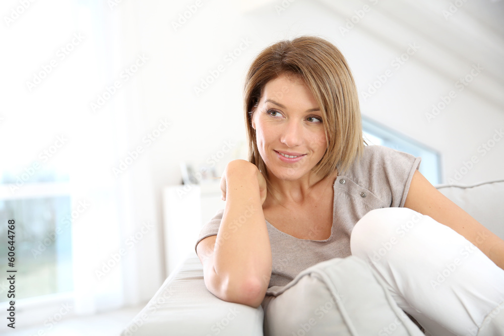 Attractive blond woman relaxing in sofa at home Attractive blond woman relaxing in sofa at home