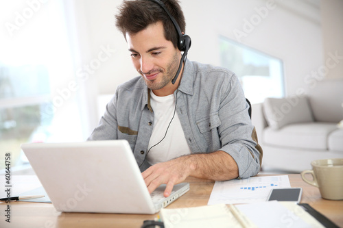 Man working from home with laptop photo