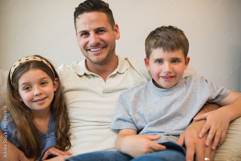 Father and children smiling on sofa Father and children smiling on sofa