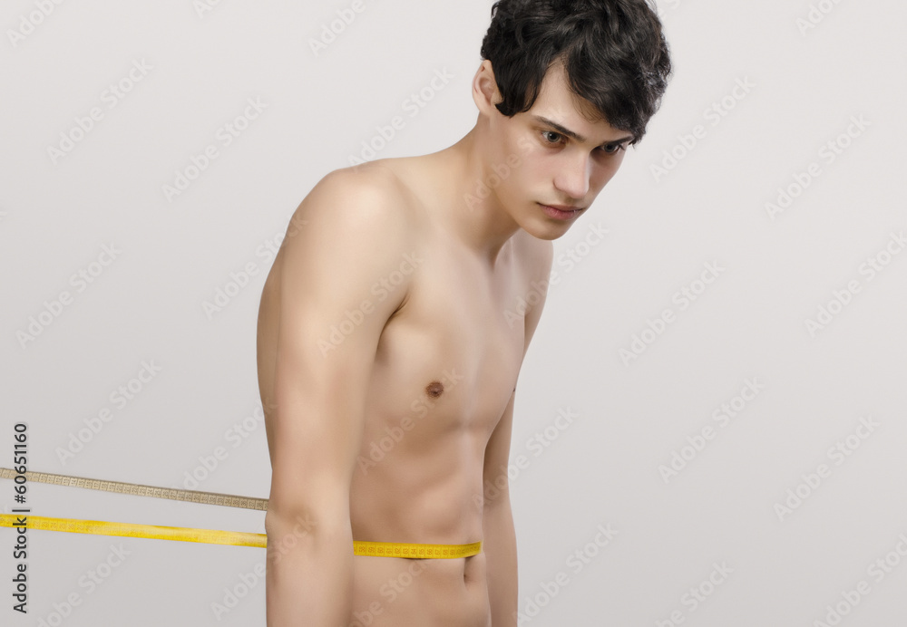Skinny young man with a centimeter, anorexic look. Slim body Stock Photo |  Adobe Stock