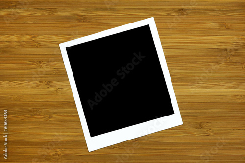 blank photo frame on wooden background