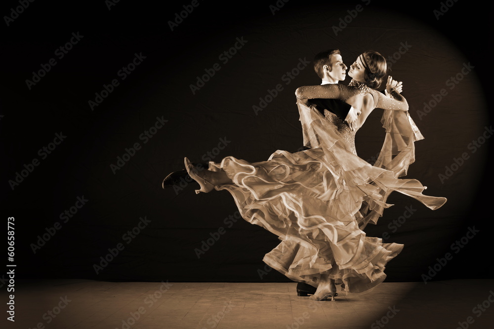 dancers in ballroom against black background