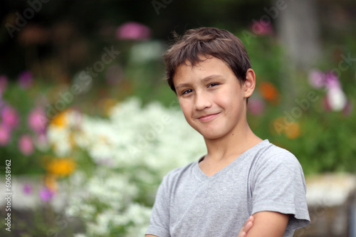 boy 10 years old against summer flower