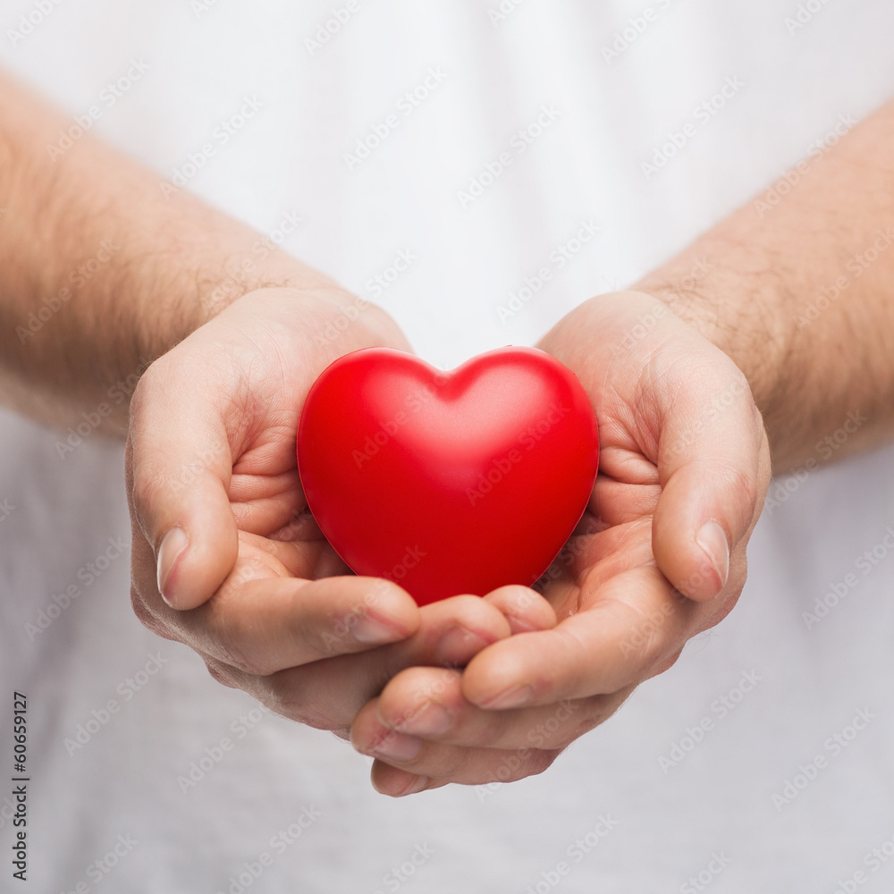 mans cupped hands showing red heart mans cupped hands showing red heart