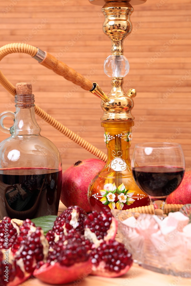 Hookah, bottle of wine and sweets