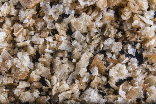 Smoked sea salt flakes, scattered to make background or texture.