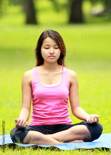 girl doing meditation on the beach