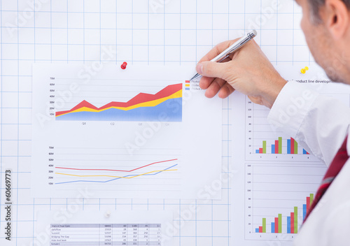 Businessman Writing On Graph