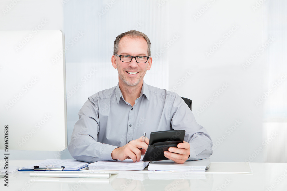 Businessman Using Calculator Businessman Using Calculator