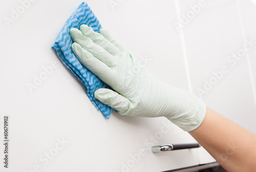 Woman Cleaning Cabinet