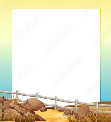 An empty paper with a fence and rocks at the bottom