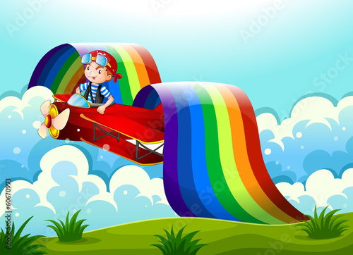 A plane with a young boy and a rainbow in the sky