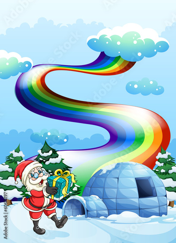 Santa Claus near the igloo and a rainbow in the sky