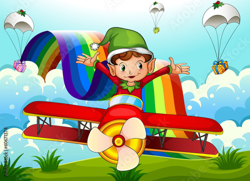 A plane with an elf and a rainbow in the sky with parachutes