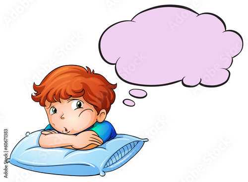 A young boy leaning over the pillow with an empty callout