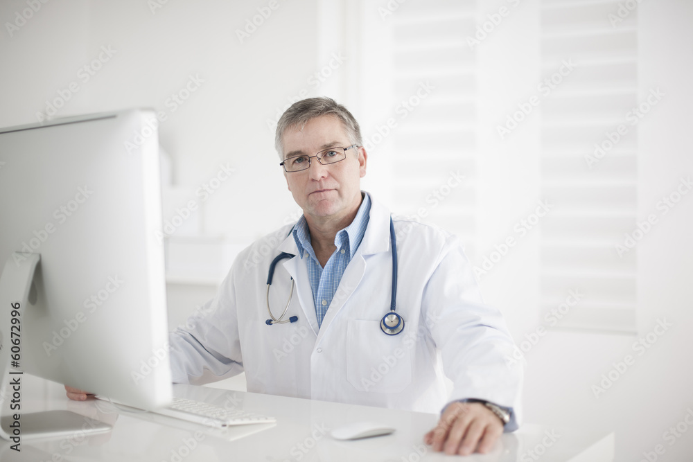 Portrait of handsome mature doctor in office Portrait of handsome mature doctor in office