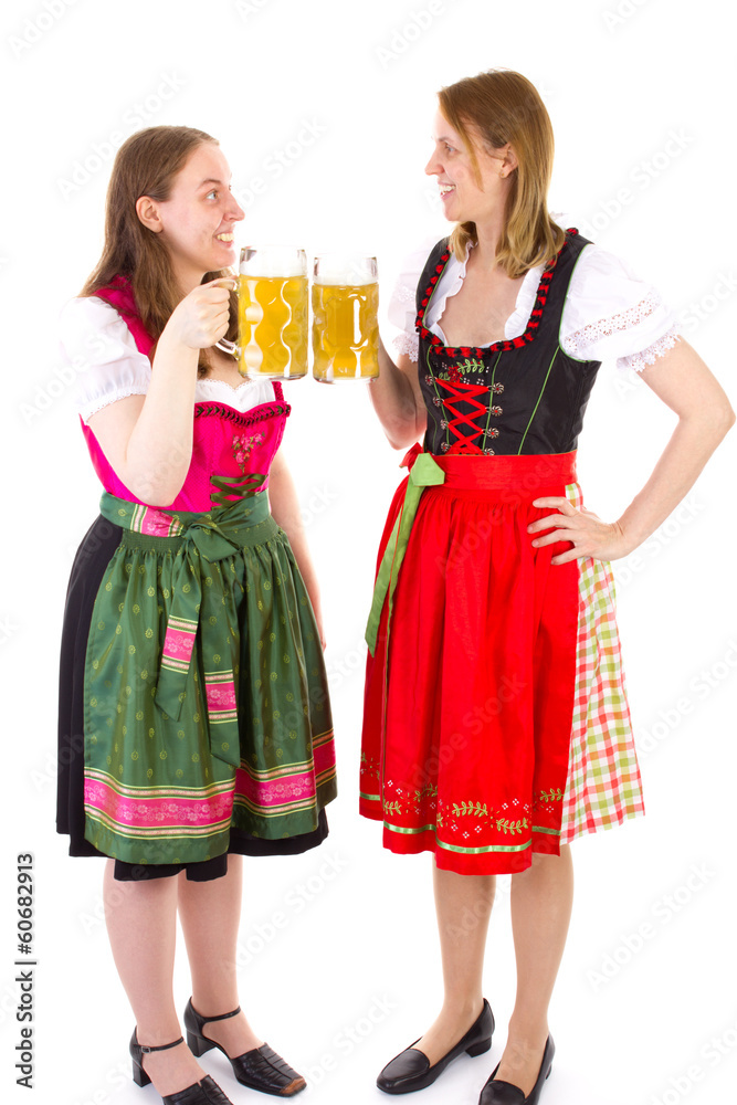 Beautiful girls in dirndl clinking their glasses Beautiful girls in dirndl clinking their glasses