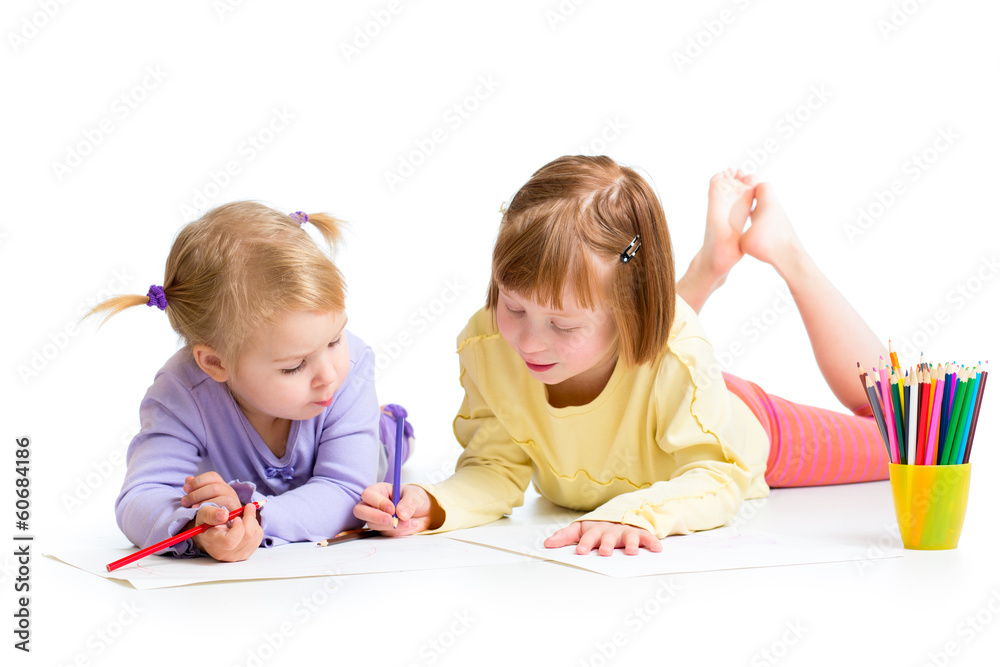 two girls drawing with color pencils together over white backgro