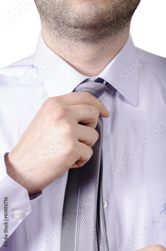 business man adjusting his neck tie