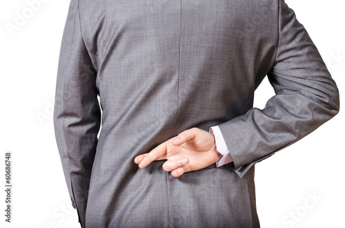 Business man with his fingers crossed behind his back