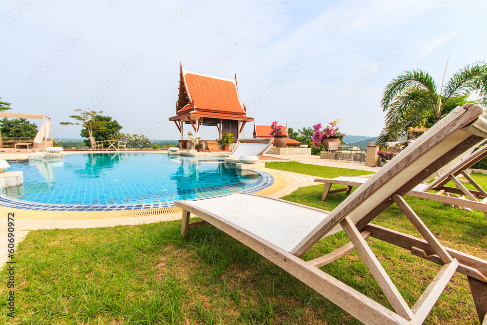 Fototapeta premium Table and chairs beside the pool
