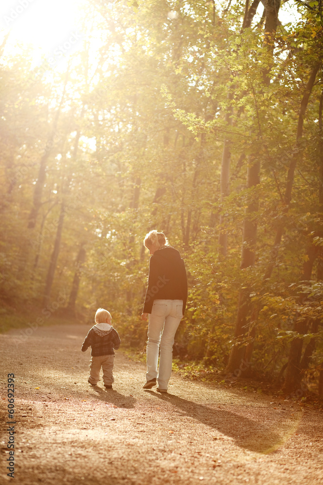 little boy with mother on outdoor walk in autumn park little boy with mother on outdoor walk in autumn park