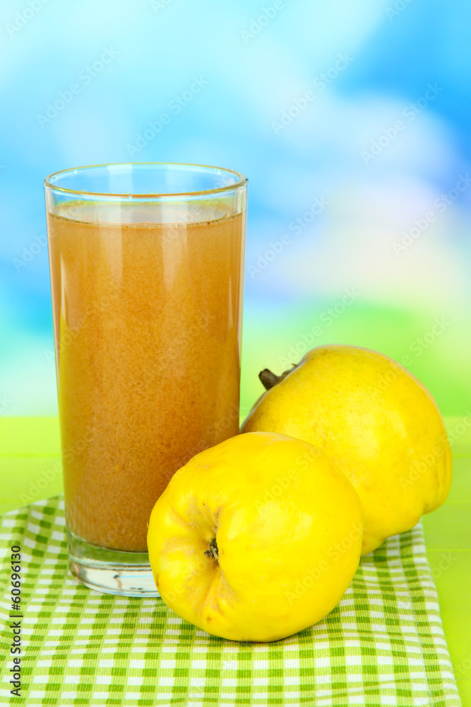Fototapeta premium Sweet quince with juice on table on light blue background