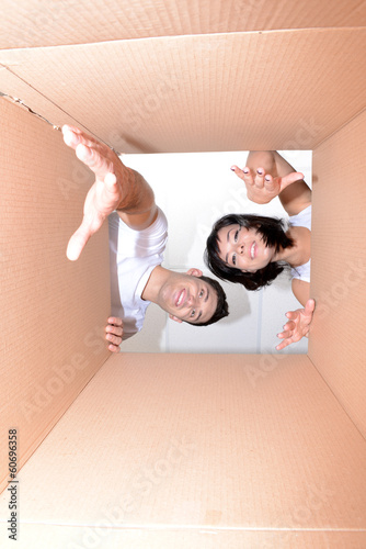 Young couple unpacking box