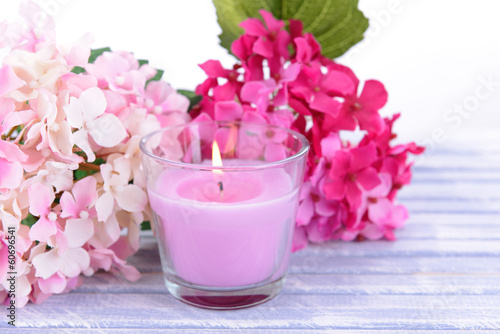 Beautiful colorful candles and flower on color wooden