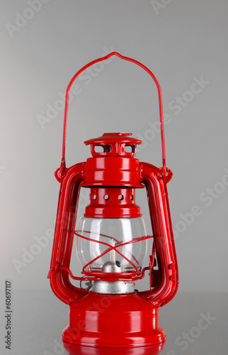 Red kerosene lamp on grey background