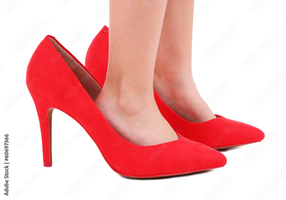 Little girl in red shoes isolated on white
