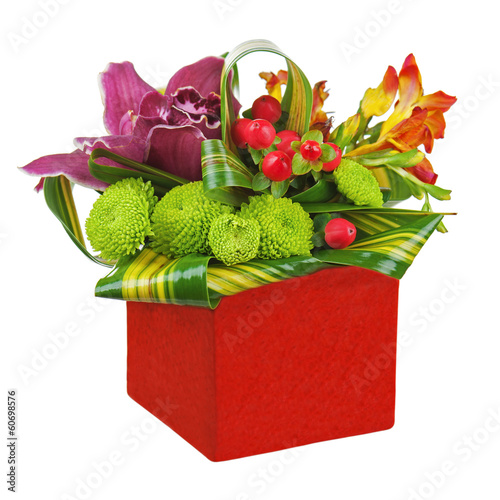 Bouquet from orchids and lilies in red vase isolated on white ba
