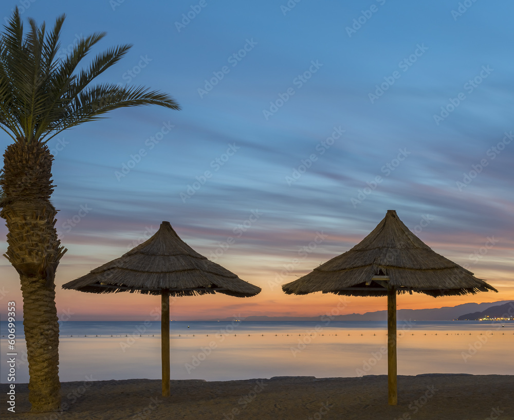 Resting silhouettes on golden beach of the Red Sea, Eilat