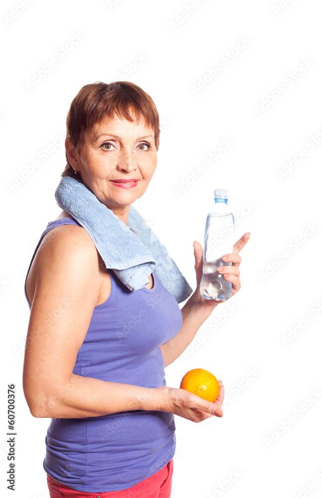 attractive woman 50 years with an orange and a bottle of water attractive woman 50 years with an orange and a bottle of water