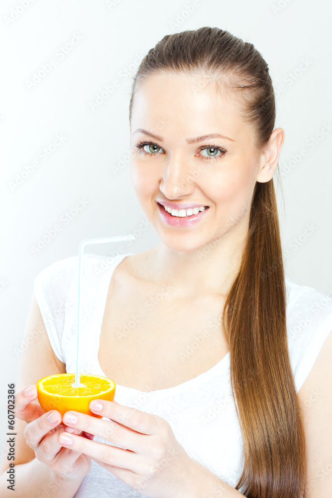 Attractive smiling young woman drinking orange juice straight fr Attractive smiling young woman drinking orange juice straight fr