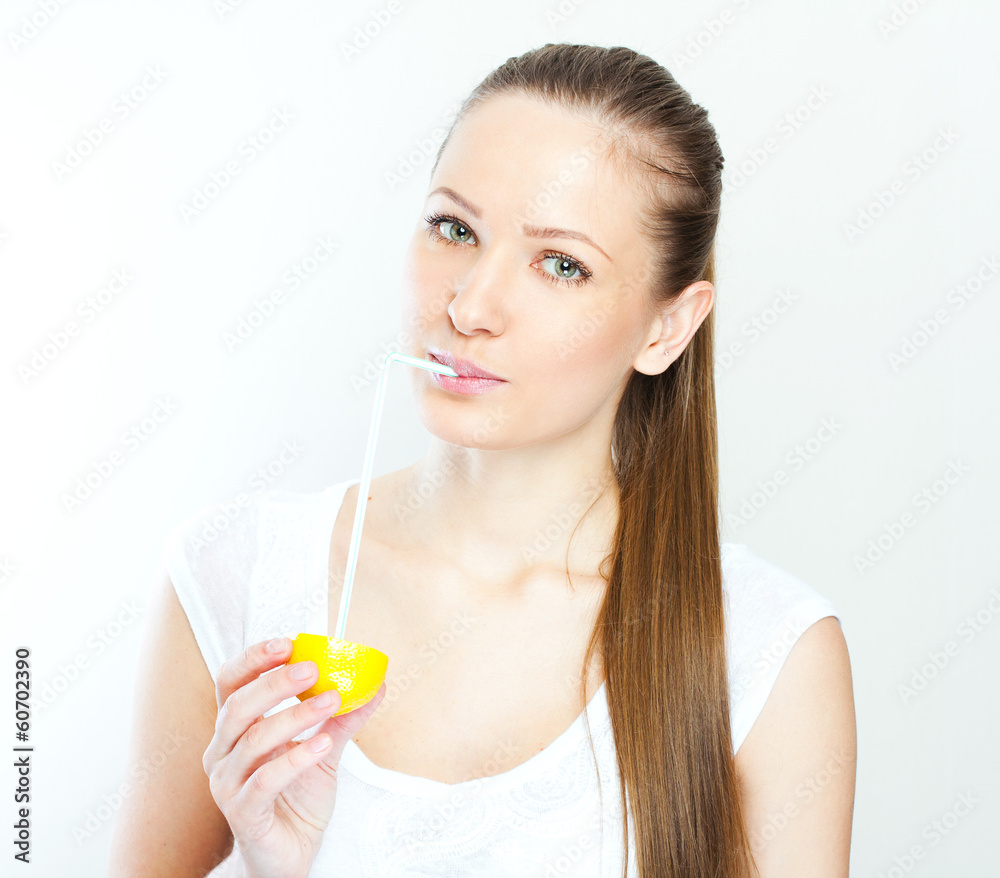 Attractive smiling young woman drinking orange juice straight fr Attractive smiling young woman drinking orange juice straight fr
