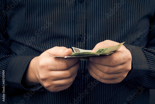 man holds hands Polish money