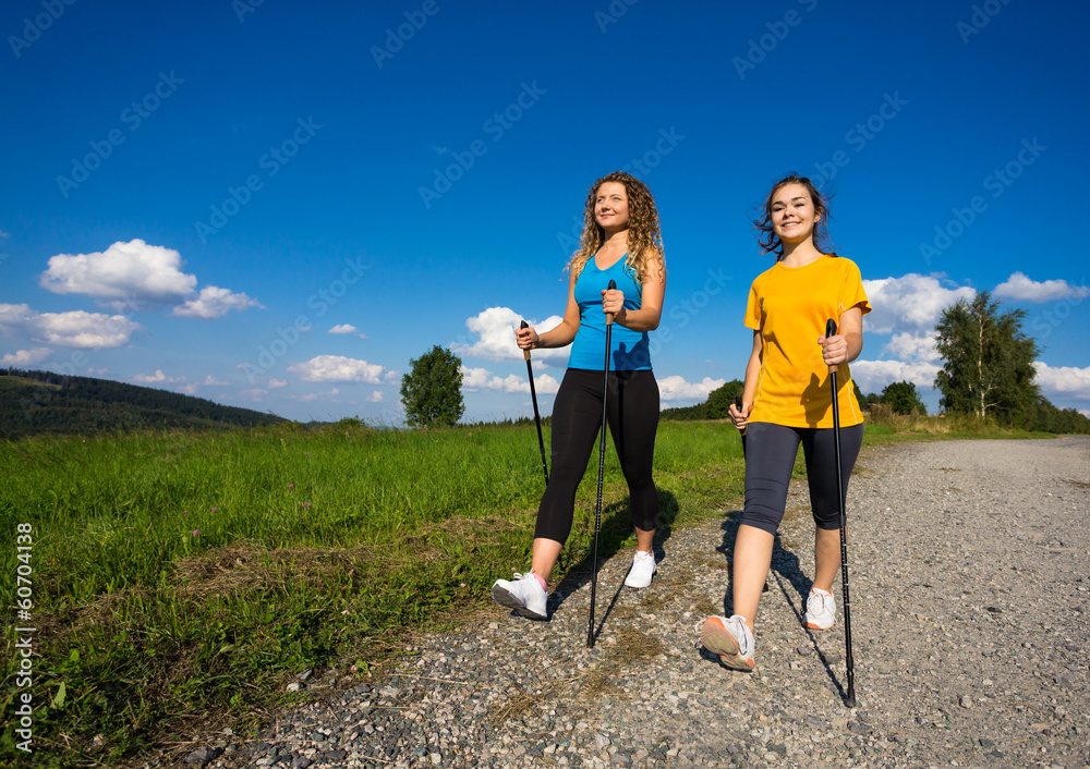 Nordic walking - active people working out outdoor Nordic walking - active people working out outdoor