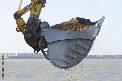 Excavator dredging a harbor photo